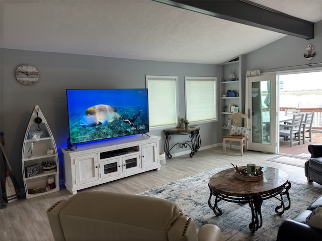 living room featuring built in features, a textured ceiling, light hardwood / wood-style flooring, and lofted ceiling with beams