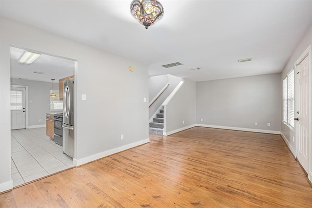 unfurnished living room with light wood-type flooring