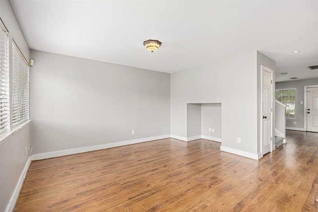 unfurnished room with wood-type flooring