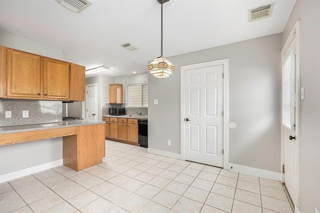 kitchen featuring black dishwasher, sink, tasteful backsplash, light tile patterned flooring, and decorative light fixtures