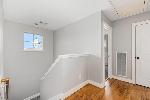 corridor with hardwood / wood-style floors