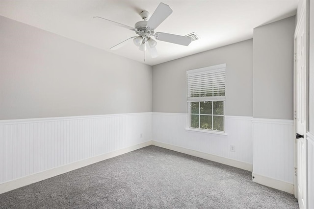 empty room featuring carpet flooring and ceiling fan