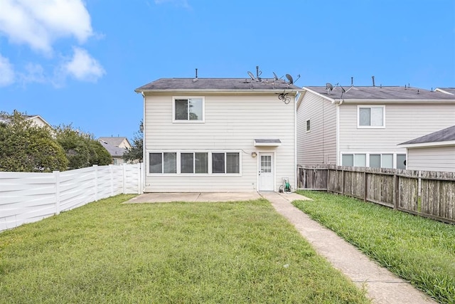 back of house featuring a yard and a patio area