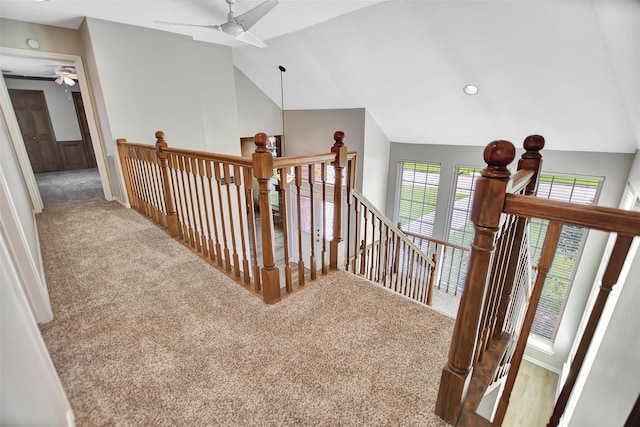 hall featuring lofted ceiling and carpet flooring