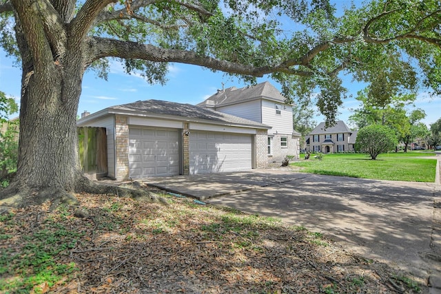 view of side of property with a garage and a lawn