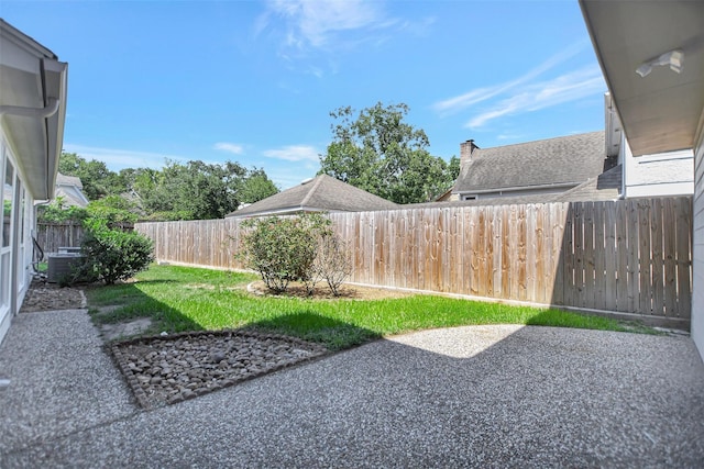 view of yard with a patio and central air condition unit