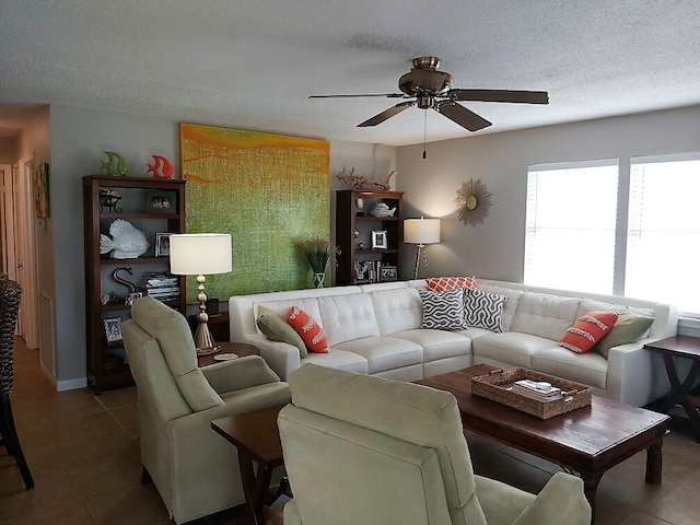 living room featuring a textured ceiling, tile patterned floors, and ceiling fan