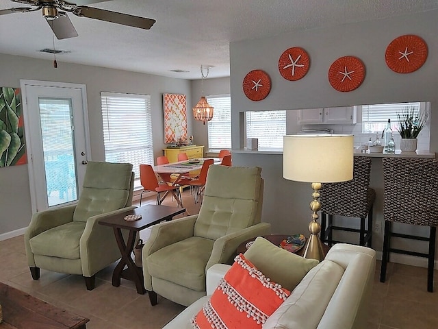 interior space featuring a textured ceiling, a healthy amount of sunlight, and ceiling fan