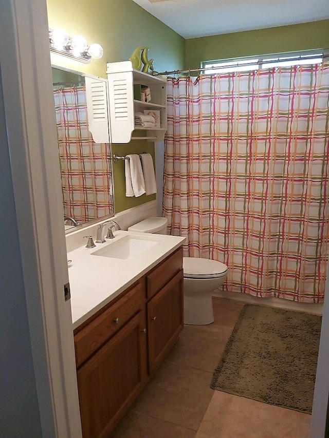 full bathroom featuring tile patterned flooring, vanity, toilet, and shower / tub combo