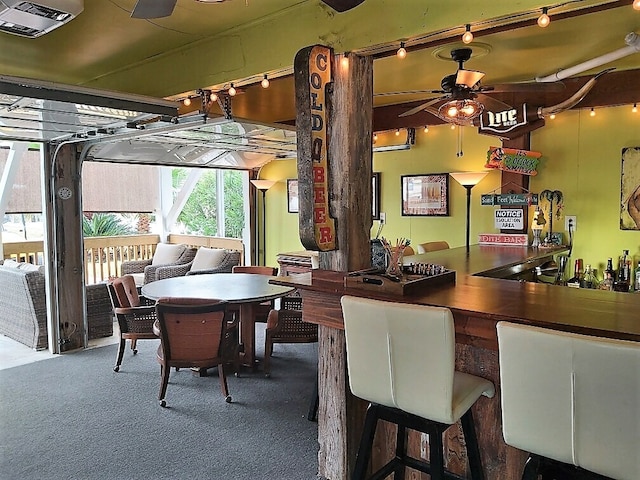 interior space featuring bar and ceiling fan