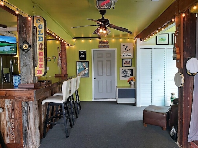 interior space featuring ceiling fan and bar