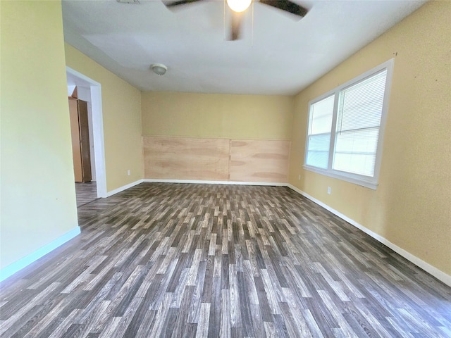 unfurnished room with dark hardwood / wood-style flooring and ceiling fan