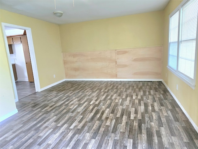 unfurnished room with dark hardwood / wood-style floors