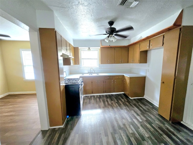 kitchen with a textured ceiling, dark hardwood / wood-style flooring, ceiling fan, and electric range