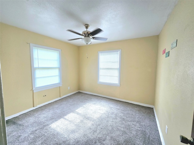 spare room with carpet, a textured ceiling, and ceiling fan