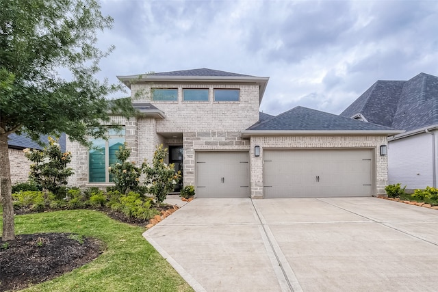 view of front of home with a front yard and a garage