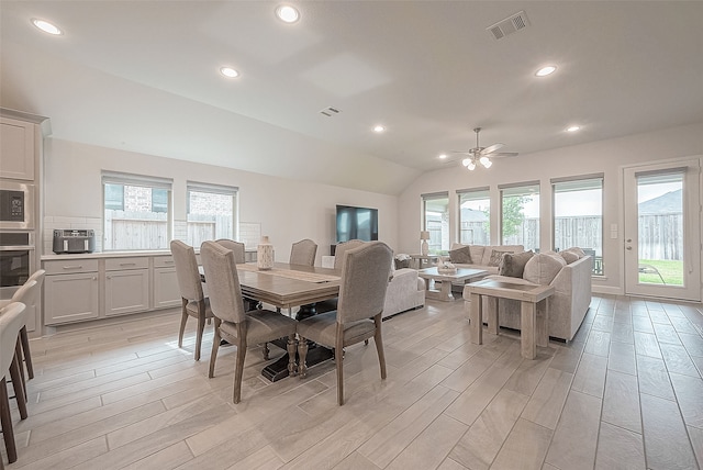 dining space featuring lofted ceiling, light hardwood / wood-style floors, and ceiling fan