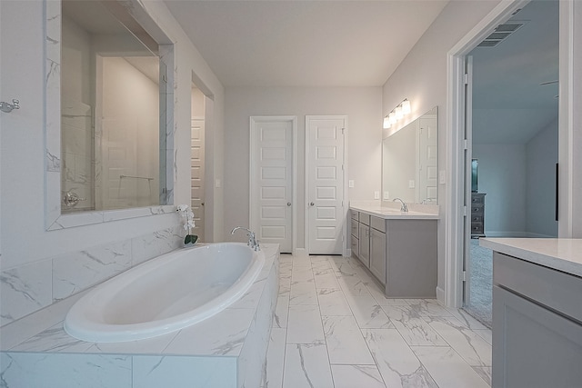 bathroom with vanity and plus walk in shower