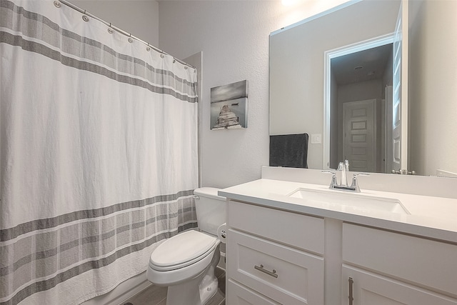 bathroom featuring vanity, curtained shower, and toilet