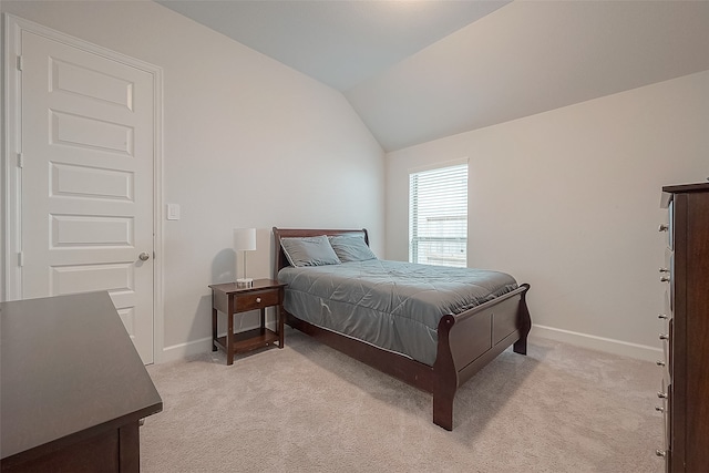 carpeted bedroom featuring vaulted ceiling