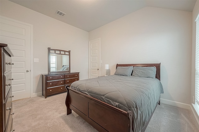 carpeted bedroom featuring vaulted ceiling