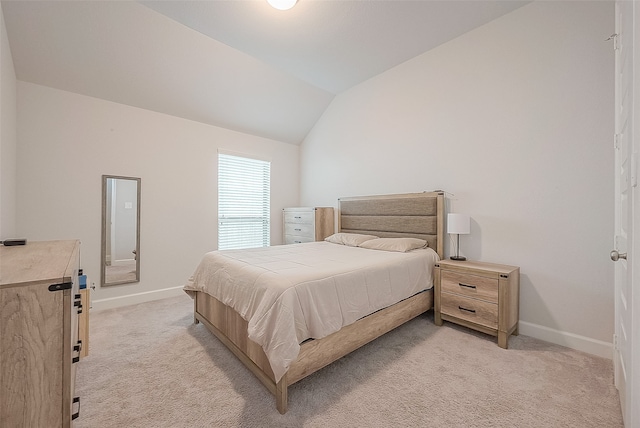 bedroom with light carpet and vaulted ceiling