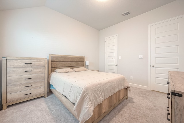 bedroom with light carpet and lofted ceiling