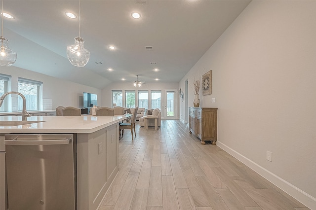 kitchen with vaulted ceiling, a wealth of natural light, decorative light fixtures, and dishwasher