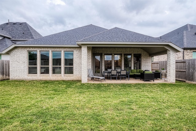 rear view of house with a patio and a lawn