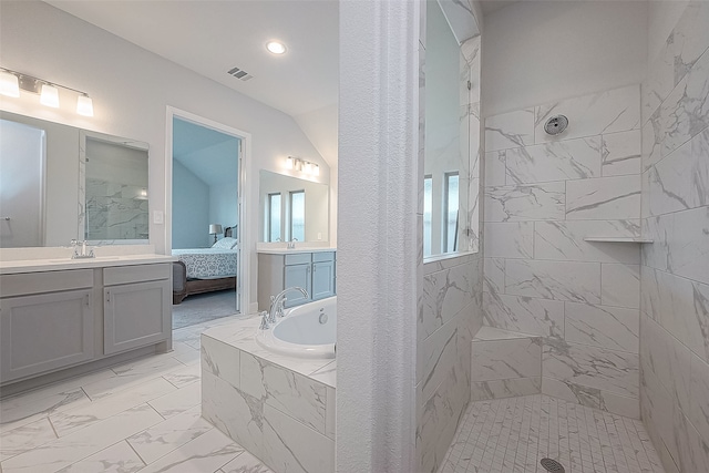 bathroom with vanity and shower with separate bathtub