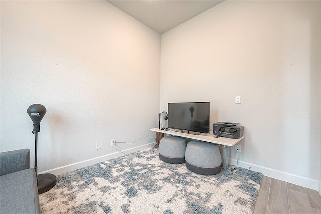 office with wood-type flooring and vaulted ceiling