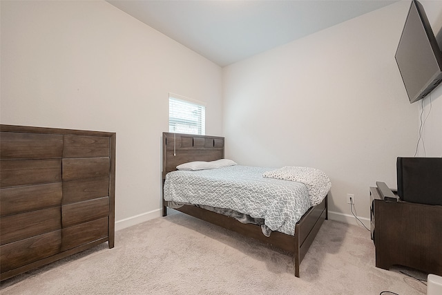 carpeted bedroom with lofted ceiling