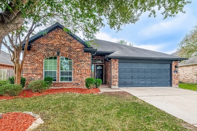 view of front of property with a garage and a front yard