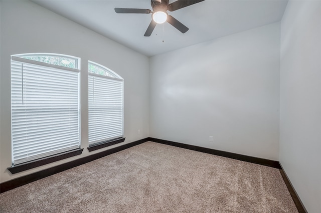 empty room featuring ceiling fan and carpet floors