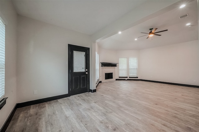 unfurnished living room featuring ceiling fan and light hardwood / wood-style floors