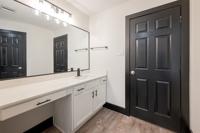 bathroom featuring vanity and wood-type flooring