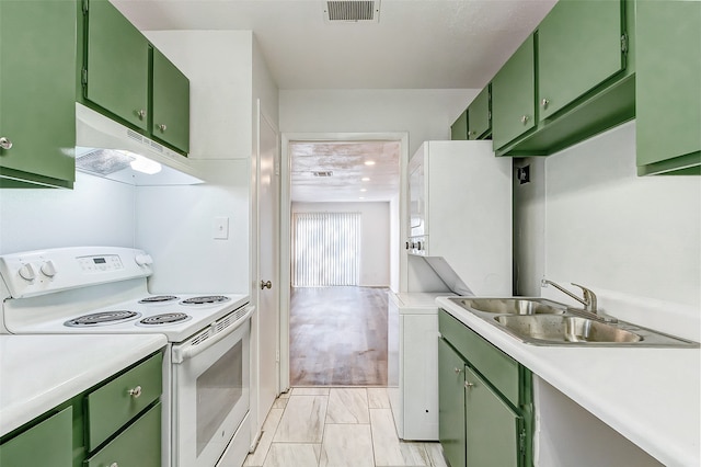 kitchen featuring white electric range oven, sink, green cabinetry, and light hardwood / wood-style floors