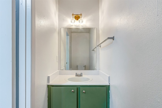 bathroom featuring toilet and vanity