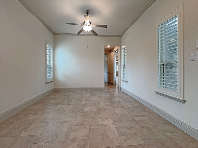 empty room featuring ceiling fan and crown molding