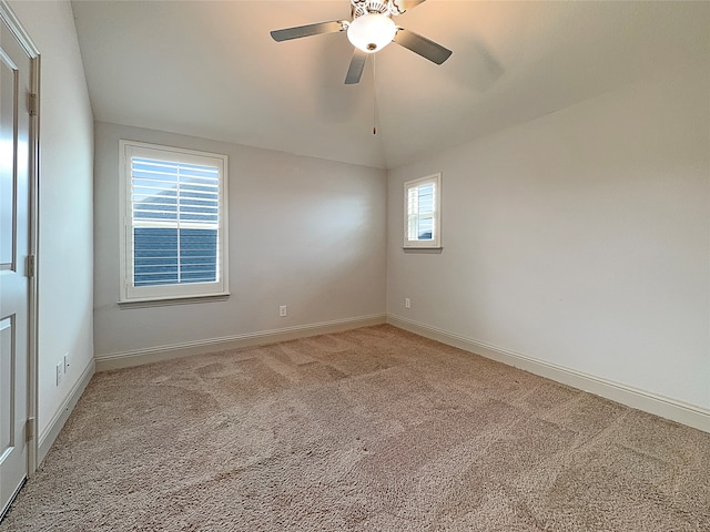 unfurnished room with a wealth of natural light, carpet floors, ceiling fan, and lofted ceiling