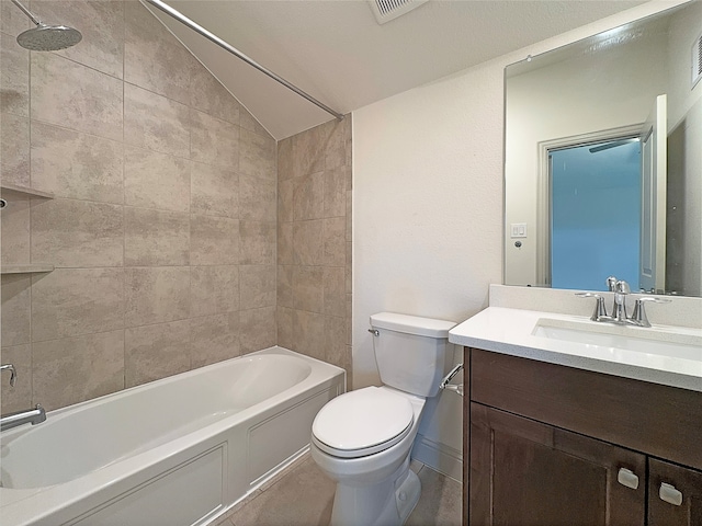 full bathroom with vanity, tiled shower / bath, toilet, and lofted ceiling