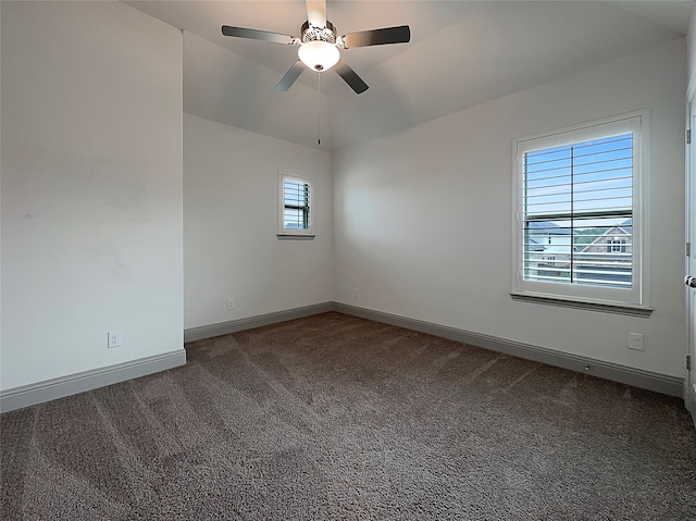 unfurnished room featuring ceiling fan and dark carpet