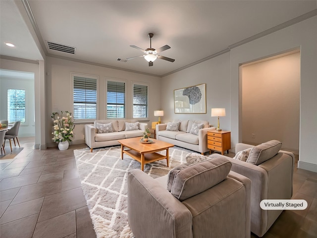 living room with ceiling fan, tile patterned flooring, a healthy amount of sunlight, and crown molding