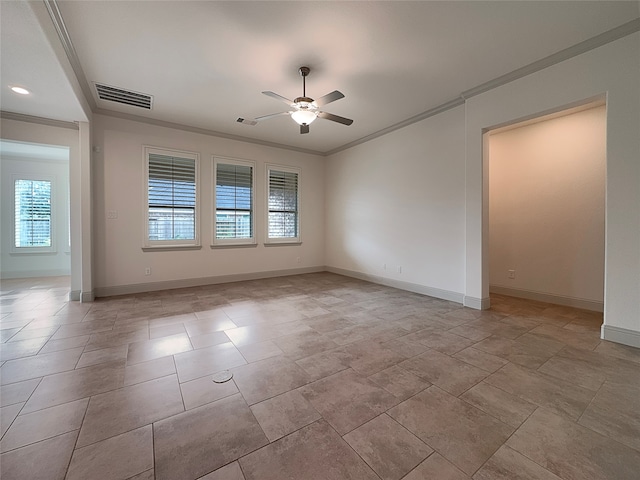 empty room with a wealth of natural light, ceiling fan, and crown molding