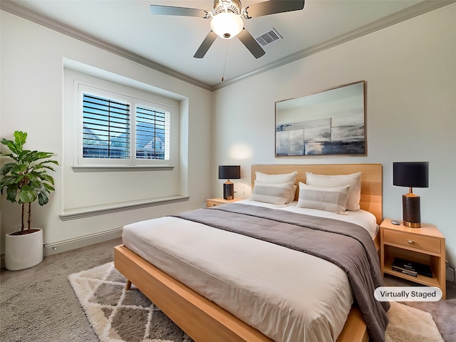 carpeted bedroom with ornamental molding and ceiling fan