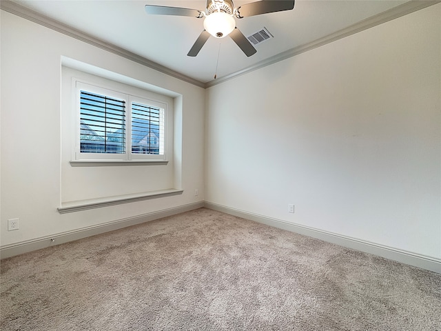 spare room featuring light carpet, ceiling fan, and crown molding