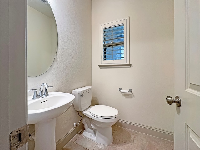 bathroom with tile patterned floors and toilet