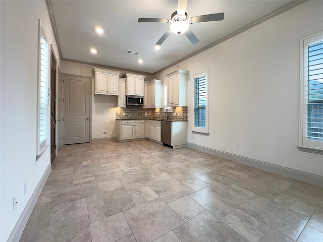 kitchen featuring stainless steel appliances, sink, tasteful backsplash, and plenty of natural light