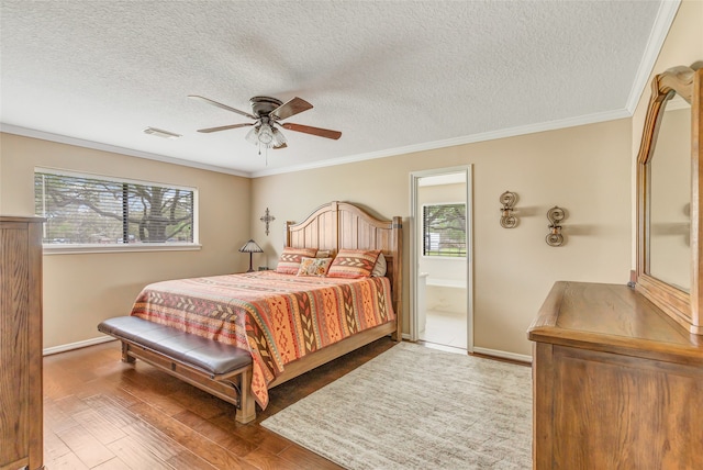 bedroom with a textured ceiling, wood-type flooring, multiple windows, and ceiling fan