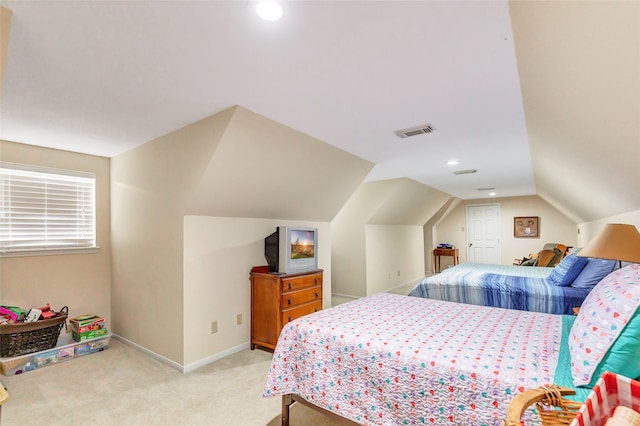 carpeted bedroom with lofted ceiling